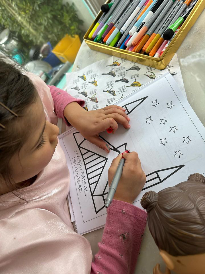 Photo: She picked the Masjid Faisal page and was glued to it the whole afternoon.